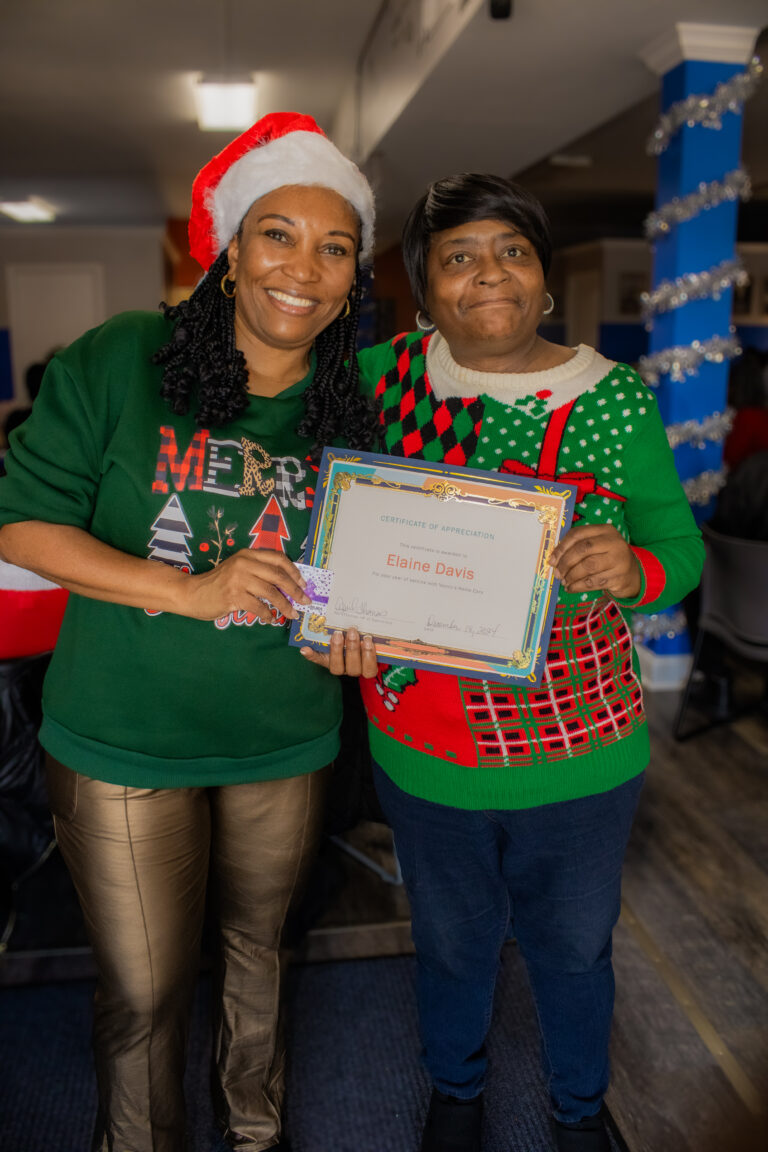 Two women holding a certificate together.