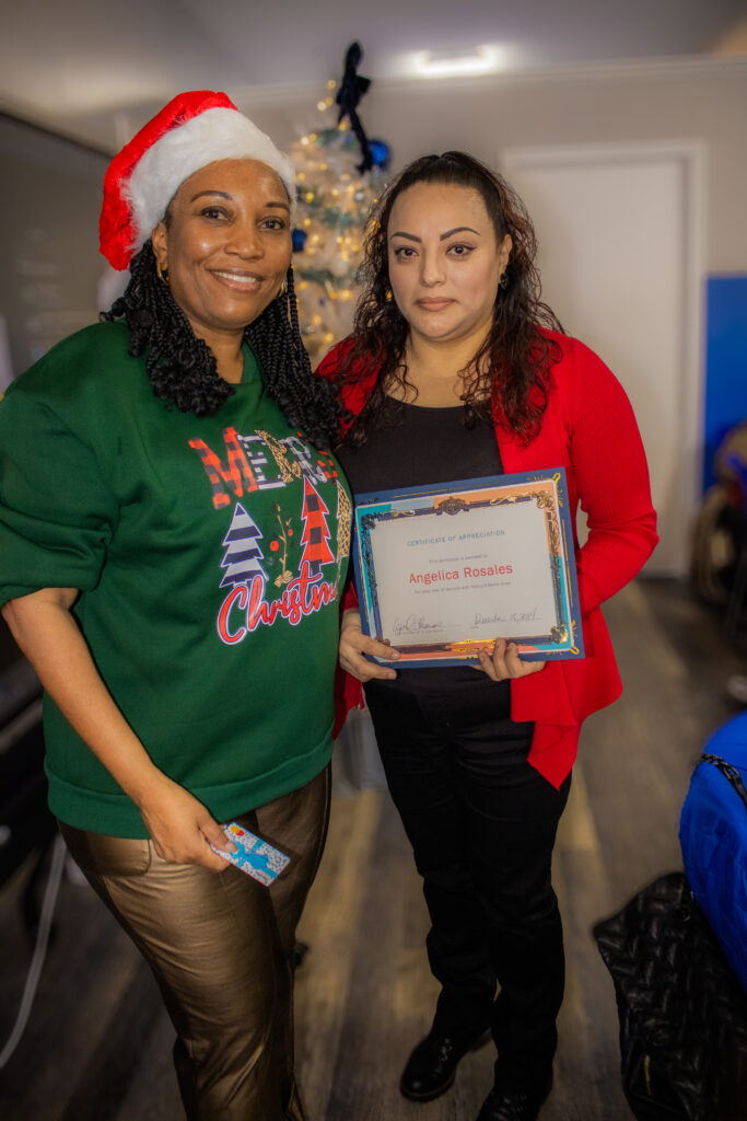 Two women holding a certificate together.